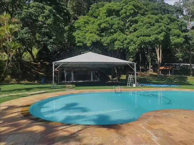 Tenda para eventos montada em área de piscina residencial